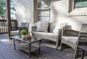Welcome to Vulcan View Suites! Come hang out on our cozy outdoor seating area, stylish wicker furniture and soft cushions, perfect for enjoying fresh air and quiet moments. A charming space to relax with a morning coffee or unwind after a busy day.
