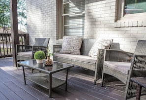 Welcome to Vulcan View Suites! Come hang out on our cozy outdoor seating area, stylish wicker furniture and soft cushions, perfect for enjoying fresh air and quiet moments. A charming space to relax with a morning coffee or unwind after a busy day.