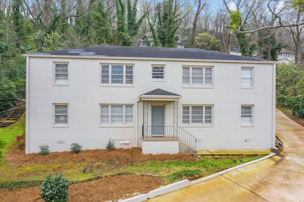 Charming and modern, the freshly painted white brick exterior of Vulcan View Suites is nestled in a serene, tree-lined neighborhood. The building's clean lines and landscaped surroundings create a welcoming first impression.