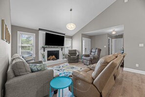 Cozy living room with smart TV and comfy (non-reclining) recliners and sofa bed.