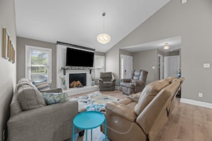 Cozy living room with smart TV and comfy (non-reclining) recliners and sofa bed.