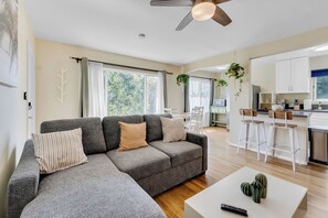 Features hardwood floors, abundant natural lighting, natural plants, Boho decor.