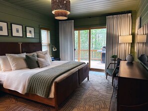 Soft green walls, luxury linens, and a king bed make Bedroom 1 a restful retreat where mornings come slowly.