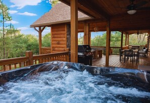Covered, cozy, and always warm, the hot tub deck offers year-round comfort with forest views and total privacy.