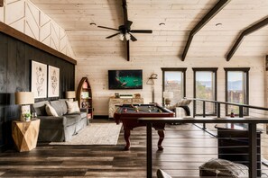Play, relax, and enjoy stunning mountain views in the game room