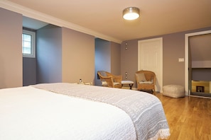 Large bedroom with seating and closet