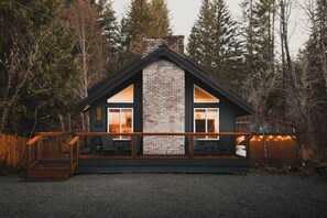 Cabin Front View - Rocking chairs & Adirondack chairs on the front deck -   perfect for sipping coffee or tea as you soak up the morning sun. A peaceful start to your day in the mountains!