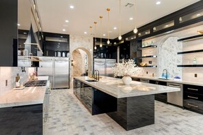 Kitchen with 16 foot island, 2 sinks, 3 dishwashers, ice maker and double fridge