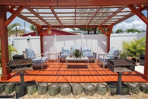 Enjoy a shared outdoor area featuring comfortable seating and a BBQ grill — perfect for relaxing or dining al fresco.