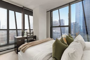 The Master bedroom with a queen sized bed & city views.