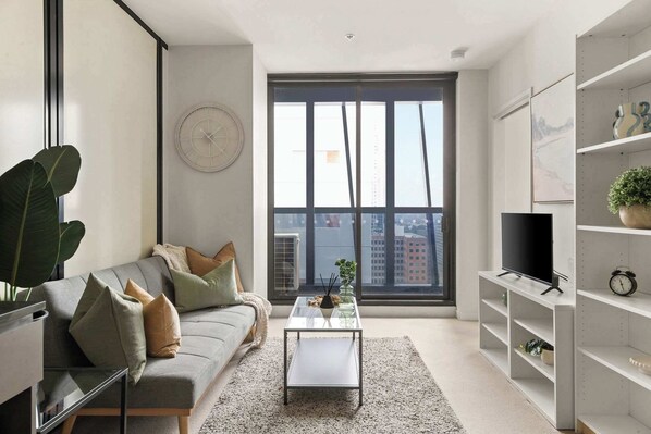 A cozy living area with a 3-seater sofa bed that folds out to a king single.