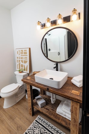 Bathroom 1 (main level): Full bathroom with walk-in shower, hair dryer