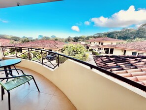 Front balcony with seating and pleasant views.