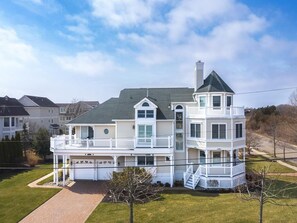 This stunning property boasts ocean views, a wrap-around porch, and a rooftop deck, perfect for soaking in the Cape May coastal charm just minutes from the beach.