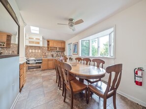 This bright kitchen offers a seamless flow into the dining space, equipped with modern appliances and a layout that facilitates family gatherings and entertaining guests.