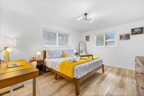 Chill in style with vibrant decor, abundant light, and a perfect workspace!
