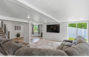 Relax in comfort with cozy seating for seven in this spacious living room.