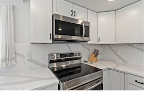 Large home kitchen has all the basic supplies for cooking and dining.