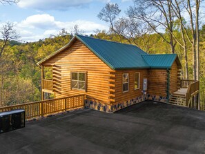 Exterior: Embrace nature in this charming log cabin with stunning woodland views!