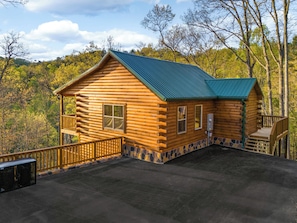 Exterior: Embrace nature in this charming log cabin with stunning woodland views!