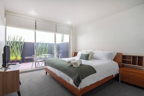 Master bedroom with king bed, tv and access to the private patio