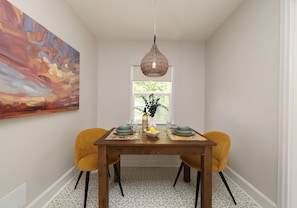 Dining nook in kitchen seating for four, bench seating in the window.