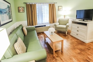 Enjoy a cozy living area featuring a sleeper sofa and an entertainment system, ideal for unwinding after a day's adventure with loved ones.