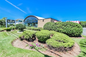The Holly Tree Resort welcomes you with its charming architecture and lush landscaping, providing a delightful start to your Cape Cod getaway.