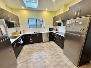 Large kitchen with two sinks, two cooktops, two fridges, coffee machine and fully equipped with your needs!