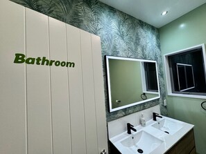Communal bathroom with 2 sinks.