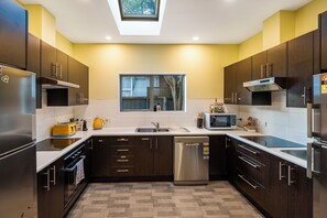 Large kitchen with two stoves, two fridges ,two sinks- plenty space for all!