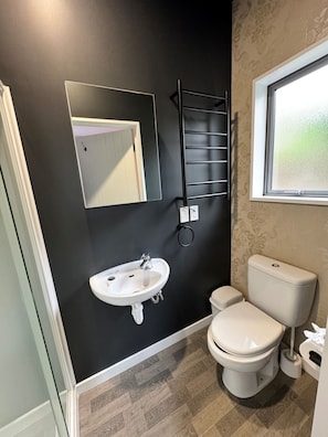 Bedroom 4 private ensuite toilet with heated towel rail and Eco Store Shampoo, Conditioner and Bodywash