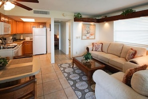 The inviting living space features a modern full kitchen and comfortable furnishings, perfect for unwinding after a day at Palm Beach attractions.