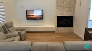 lounge room with TV and gas fireplace