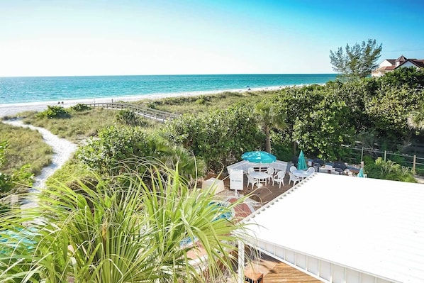 Experience breathtaking beachfront views from the side-view balcony of this inviting 2BR condo at Sand Pebble in Treasure Island, FL.