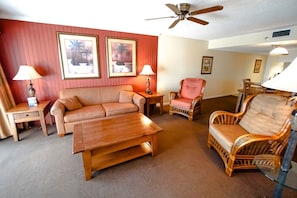 Relax in a cozy living area that boasts ample seating and a charming atmosphere, ideal for unwinding after beach adventures, complete with modern amenities like a smart TV and Wi-Fi.