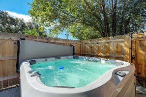 Relax and unwind in the shared hot tub, the perfect spot for a soothing soak after a day of exploring Colorado Springs.