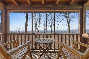 Enjoy a cozy morning coffee or a quiet evening with a loved one on the deck's comfy seating for two, complete with a charming coffee table.