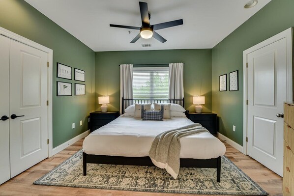 Bedroom 1: Sink into comfort in our beautifully styled king bedroom, complete with plush bedding, a Smart TV for your favorite shows, and a sleek modern lamp that sets the perfect mood. 