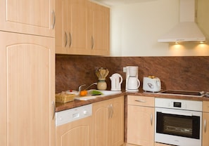 Prepare meals in the full kitchen and enjoy them at the dining table.