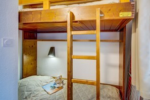 The cozy sleeping alcove features a bunk bed.