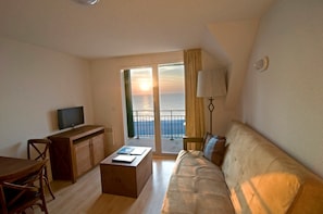 Find peace and relaxation with your close friends and family in this lovely living room with sea view!
