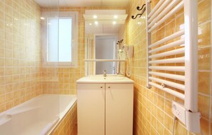 Get ready for your day in the bright bathroom.