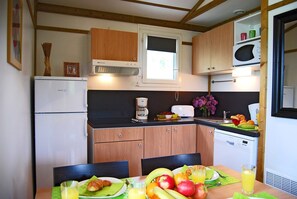 Prepare meals in the kitchenette and enjoy them at the dining table.