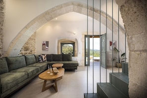 Living room with a lush sofa and a 50” TV
