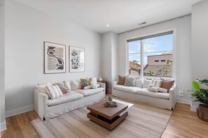 Cozy, spacious, professionally designed living room situated off the kitchen. Flat screen TV and lots of seating makes this room ideal for convening and relaxing.