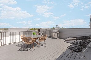 Spacious rooftop deck with outdoor seating + BBQ Grill and views of the city.