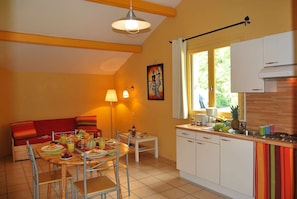 Prepare meals in the kitchenette and enjoy them at the dining table.