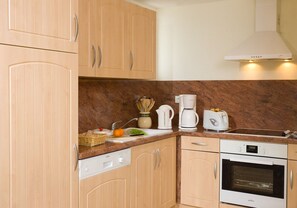 Prepare meals in the full kitchen and enjoy them at the dining table.