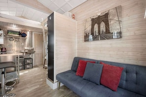 Experience cozy living in this stylish space with a lofted bed and modern decor, perfect for a unique getaway!